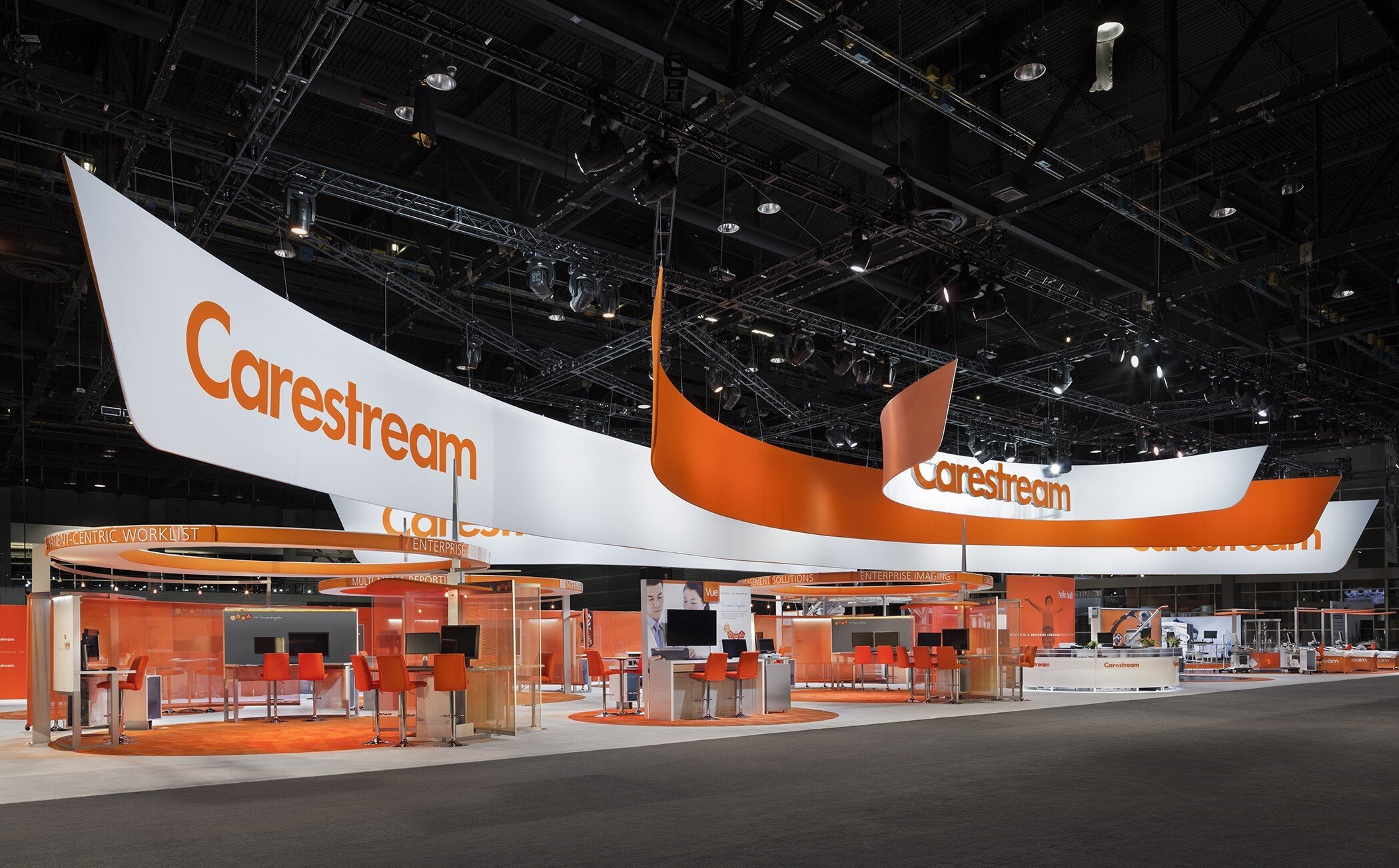 80x160 large-scale custom exhibit design at ASCO showcasing healthcare demonstrations and modern booth architecture