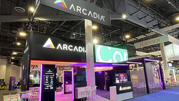 Close-up of branded elements and digital lighting effects in Arcadia’s healthcare IT exhibit booth at HIMSS.