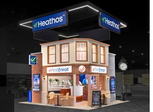 Heathos 20x20 trade show booth designed like a multi-brand storefront village with illuminated overhead sign