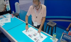 Experiential trade show tech exhibits highlighting LED screens, AR displays, and interactive touchscreen experiences.