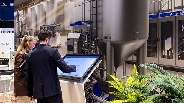 Hands on interaction in Tetra Pak booth showcasing products at the 2024 Pack Expo packaging trade show